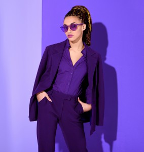 stylish african american girl posing in purple suit and sunglasses, ultra violet trend