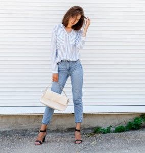 Young stylish woman wearing blue striped shirt, blue cropped den